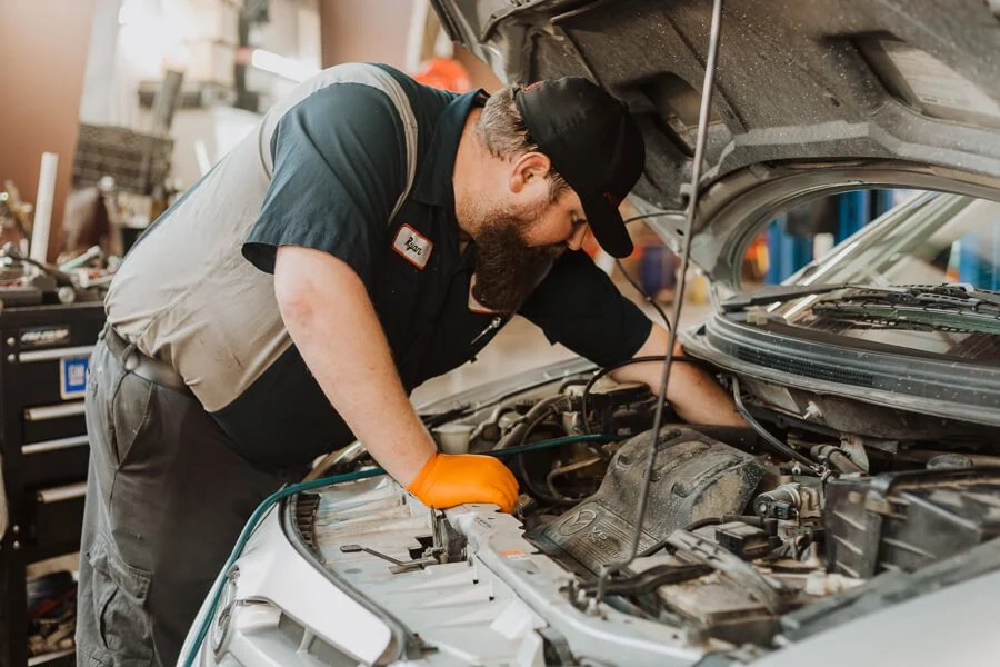 Mobile mechanic inspecting a work van for Long Island commercial vehicle wear onsite